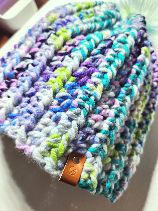 Multicolored knitted product with a brown tag on a white background