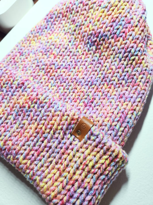 Multicolored knitted product with a brown leather patch on a white background