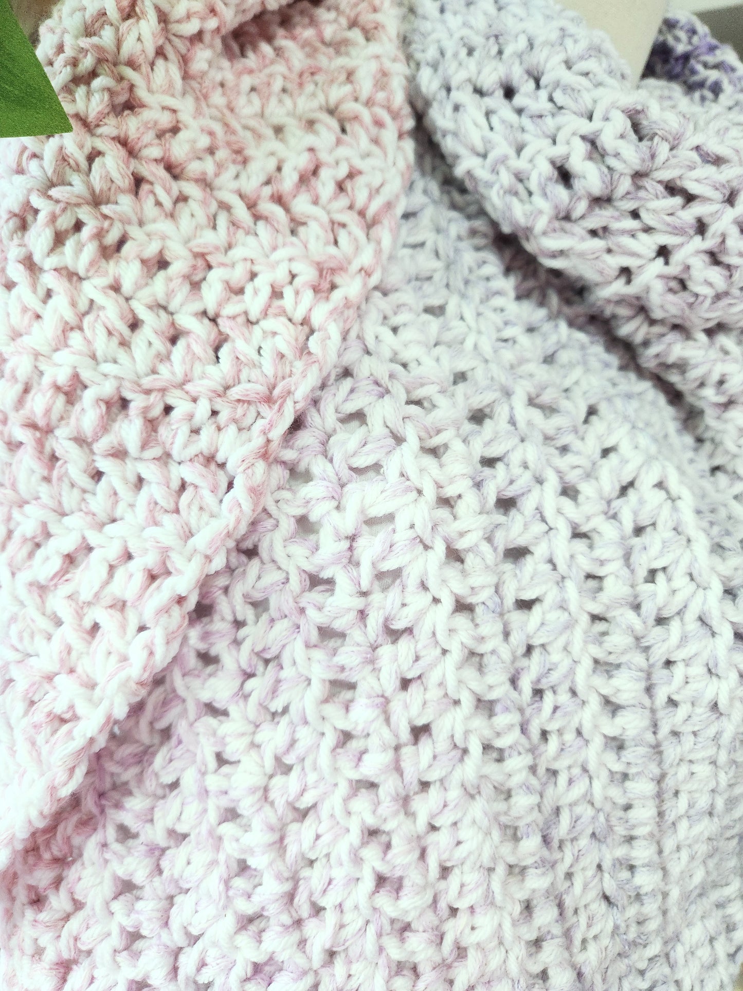 Close-up of a knitted fabric with pink and white colors.