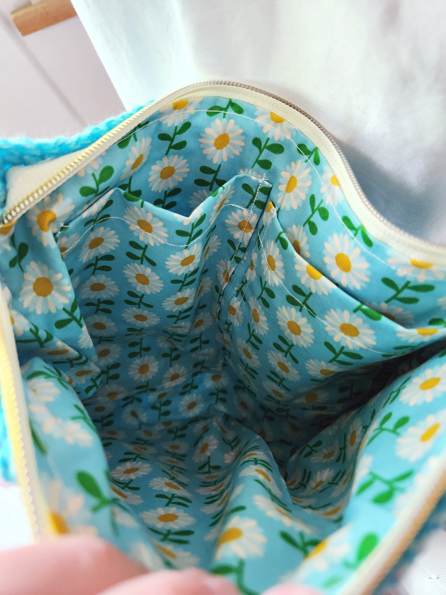 Close-up of a fabric interior with daisy pattern on a blue background