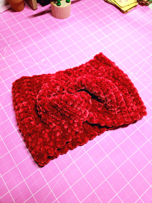 Red knitted fabric on a pink grid background