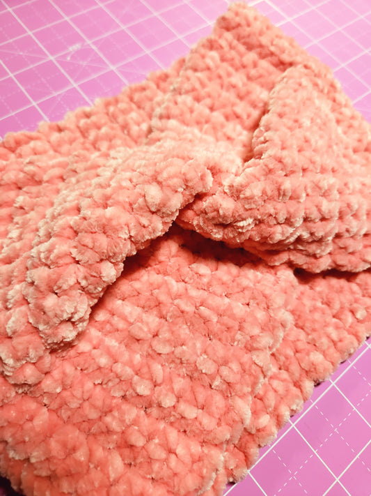 Pink textured fabric on a pink grid background