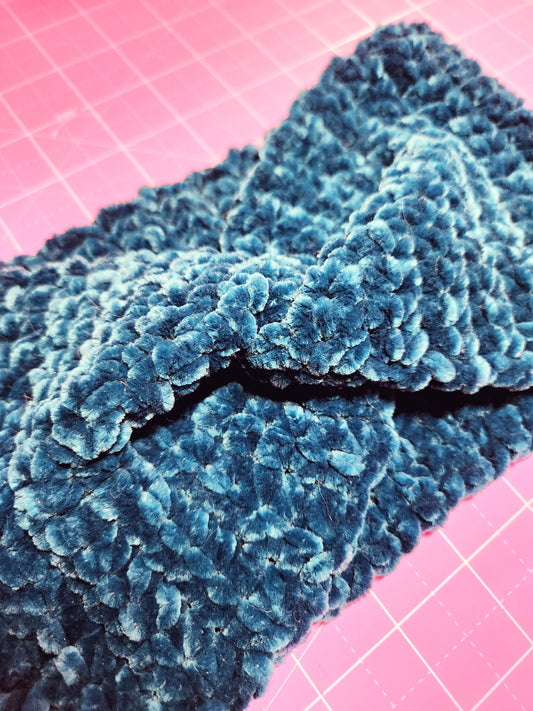 Blue textured fabric on a pink grid background