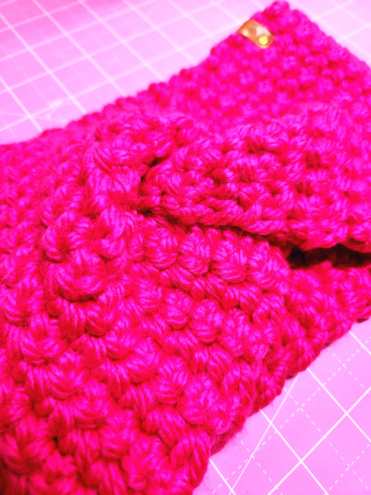 Close-up of a pink knitted fabric on a pink grid background