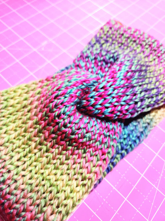 Colorful knitted fabric on a pink grid background