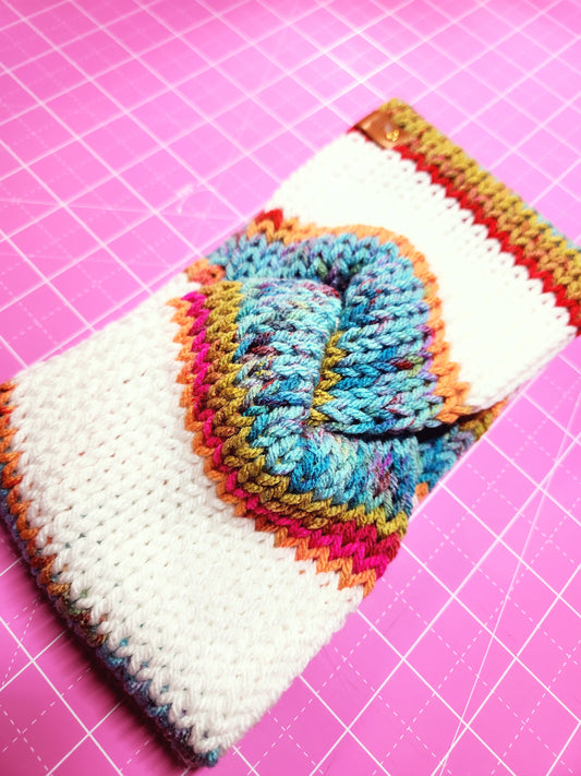 Colorful knitted swatch on a pink grid background