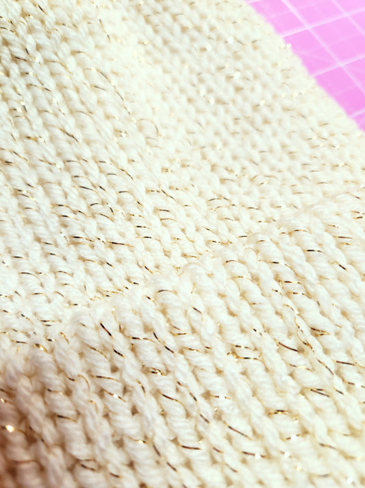 Close-up of textured beige fabric with a pink grid background
