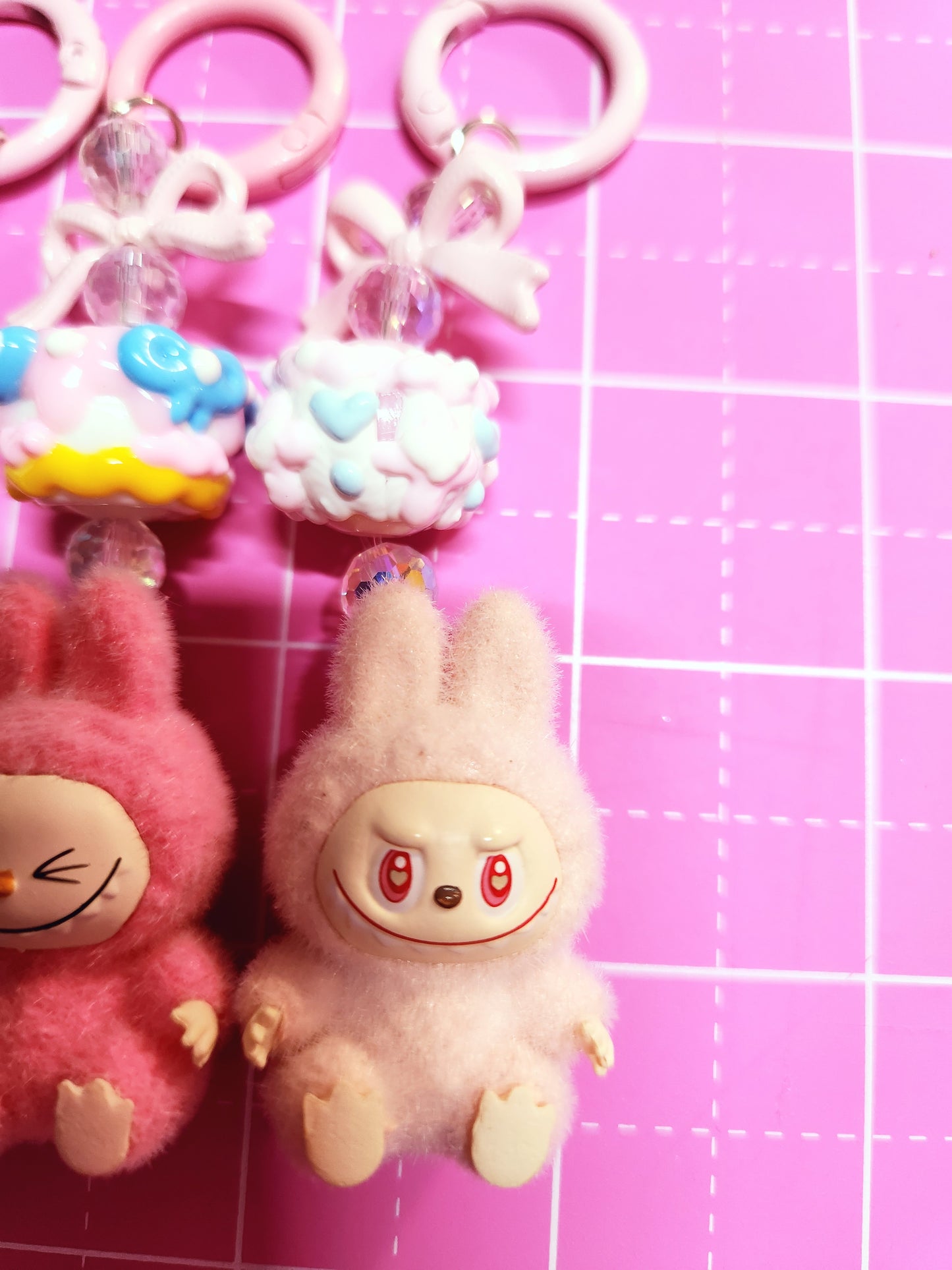 Toy monkey and other toys on a pink grid background