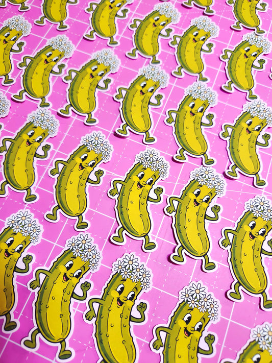 Pattern of cartoon pickles with dandelions on a pink grid background