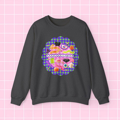 A dark gray crewneck sweatshirt featuring a colorful retro-style graphic print on the front with the text 'I DON'T LIKE APPLES' over a pink and purple gingham pattern, displayed against a light pink grid background.