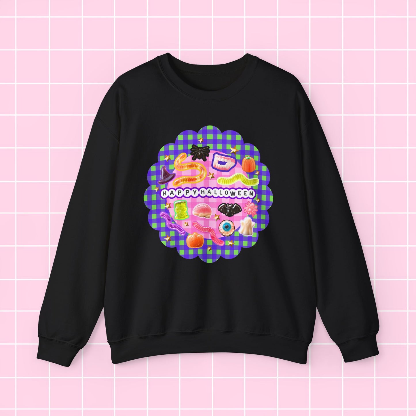 A black crewneck sweatshirt featuring a colorful retro-style graphic print on the front with a purple and green plaid scalloped border and the text 'GREAT GATSBY SESSION'. The sweatshirt is displayed flat against a light pink grid background.