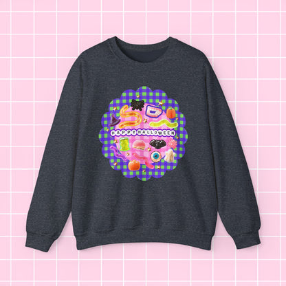 A dark heather gray crewneck sweatshirt featuring a colorful retro-style graphic on the chest with the text 'HAPPY OCCASIONALLY' over a pink and purple gingham pattern, displayed against a light pink grid background.