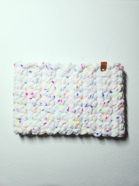 Textured white clutch with colorful speckles on a light gray background