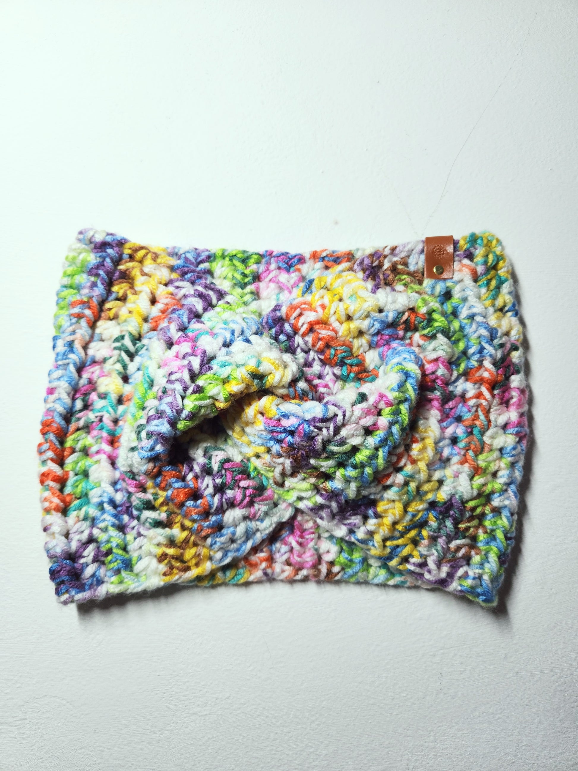 Colorful crocheted hat on a light gray background
