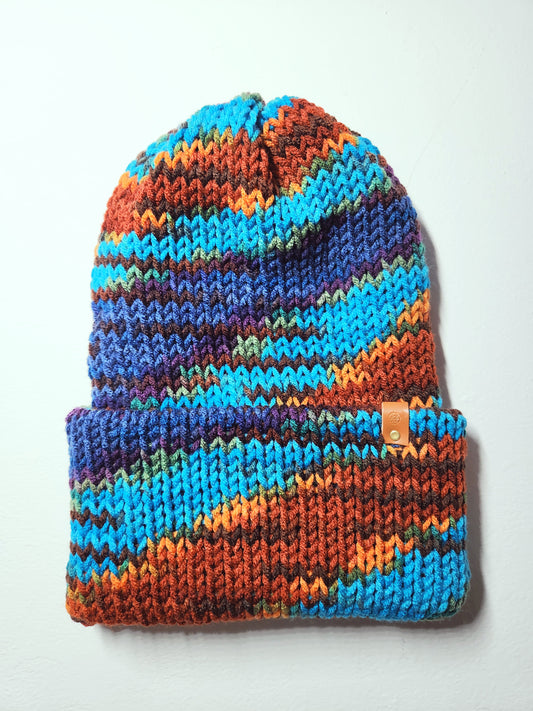 Colorful knitted beanie with a pattern on a white background