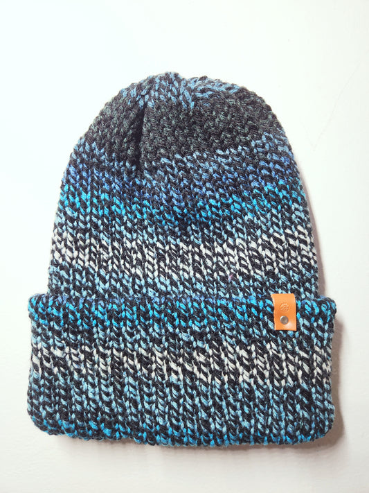 Knitted beanie with a blue and gray pattern on a white background