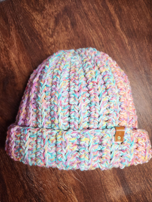 Multicolored knit beanie on a wooden surface