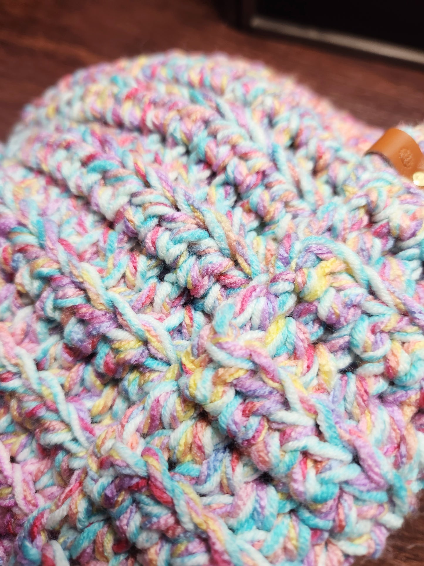 Multicolored knitted yarn on a wooden surface