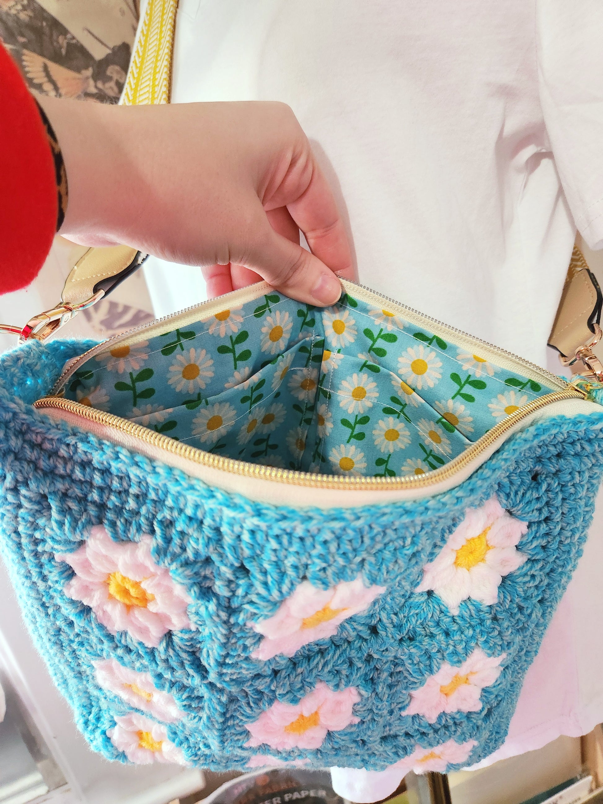 Blue woven bag with floral patterns on a white background