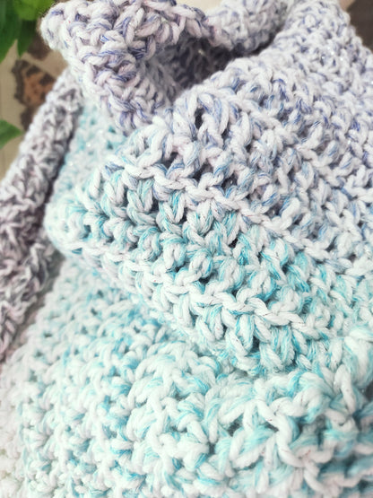 Close-up of a crocheted blanket with blue and gray pattern