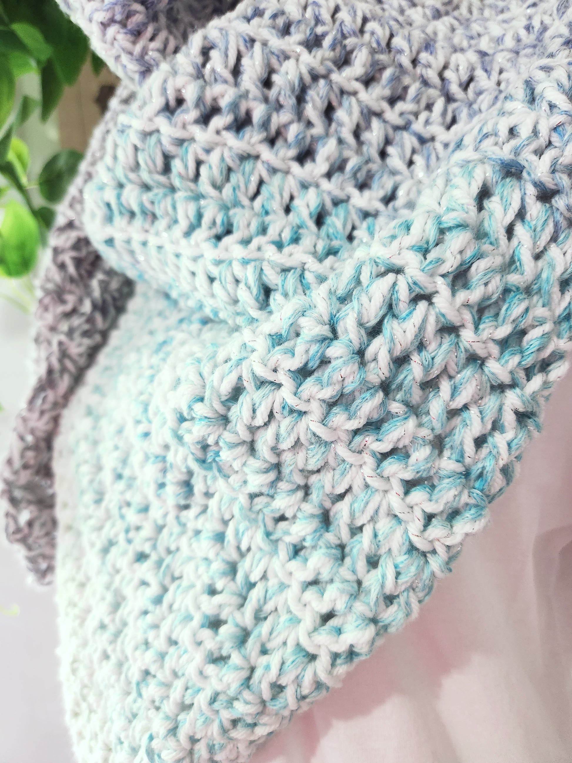 Close-up of a knitted fabric with a textured pattern on a mannequin.
