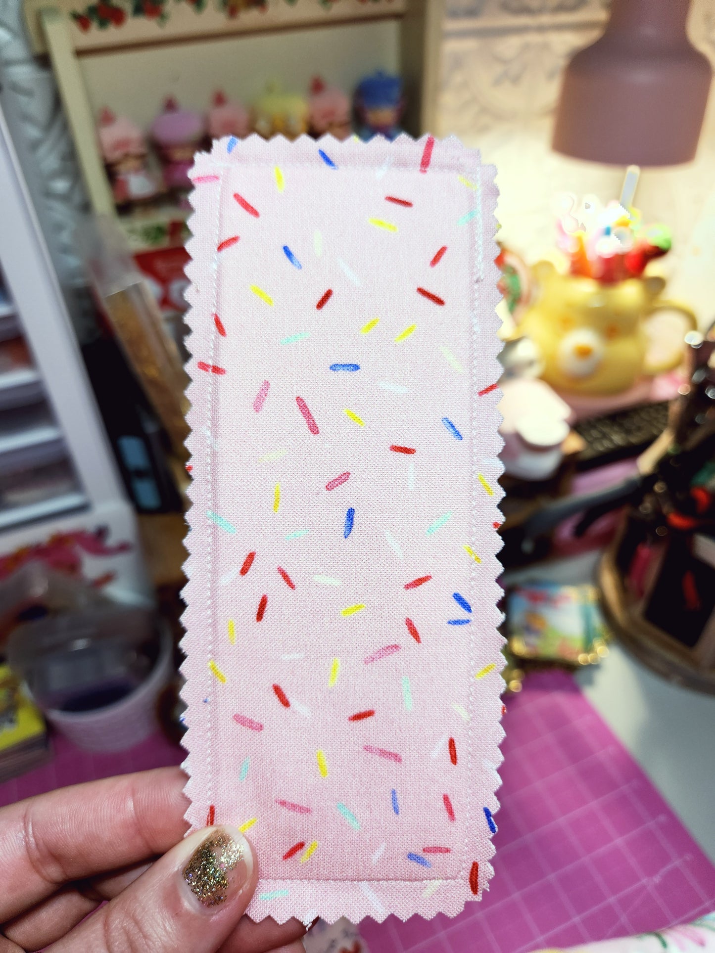 Colorful fabric with sprinkles held in front of a blurred background