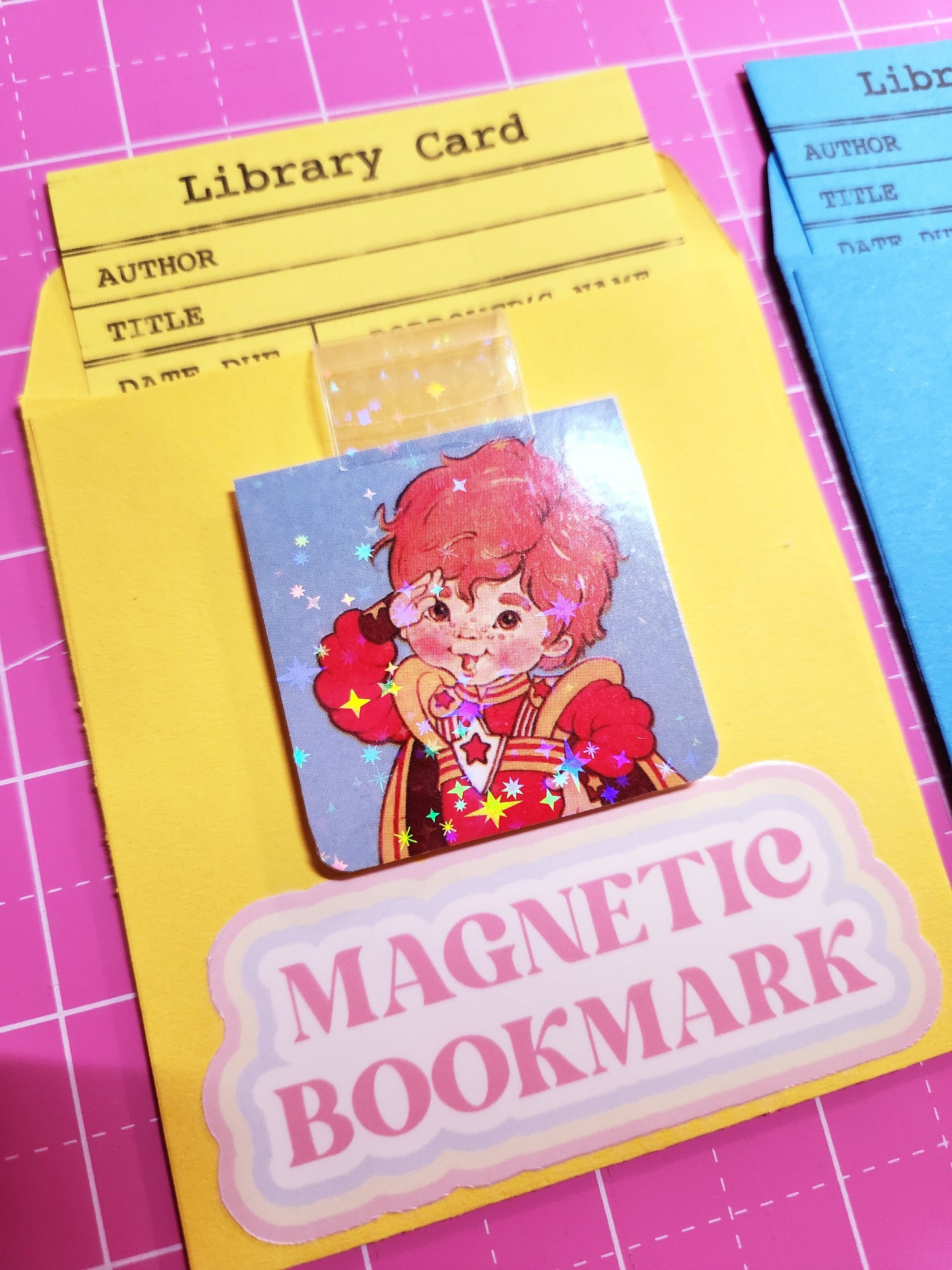 Set of magnetic bookmarks with various designs on a pink grid background