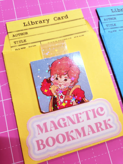 Set of magnetic bookmarks with various designs on a pink grid background