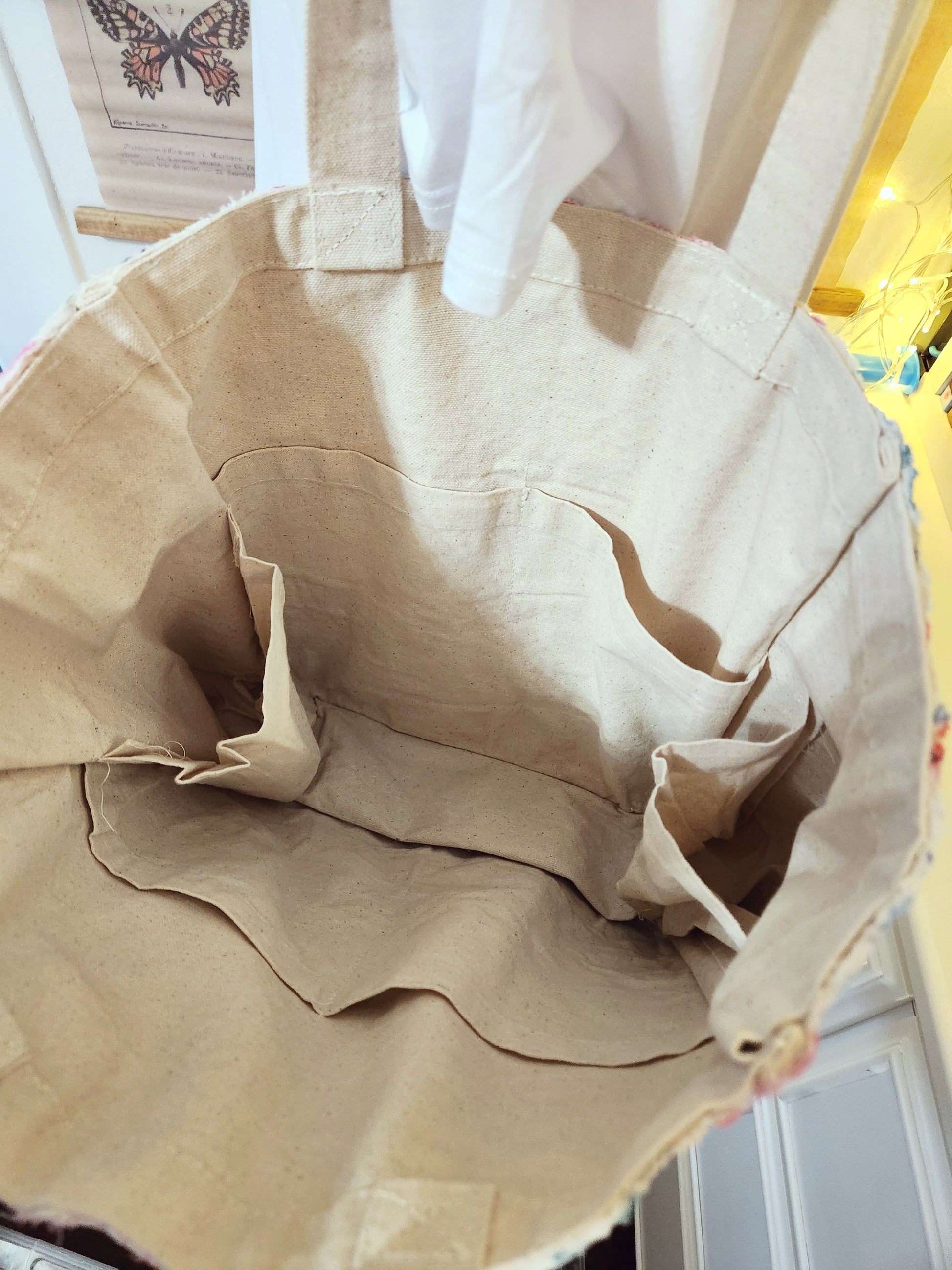 Beige tote bag with a butterfly design in the background