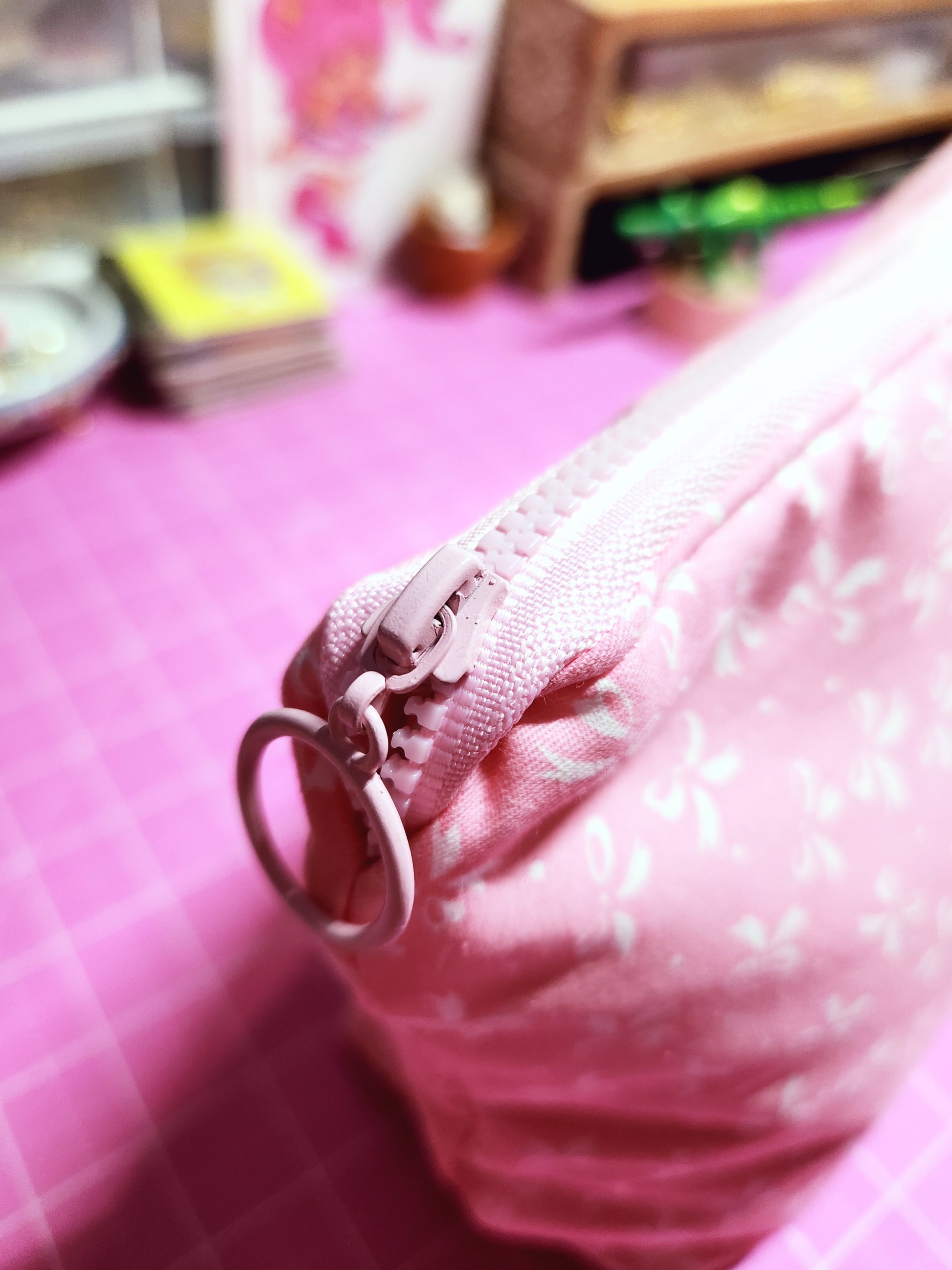 Close-up of a pink garment with a zipper on a blurred background