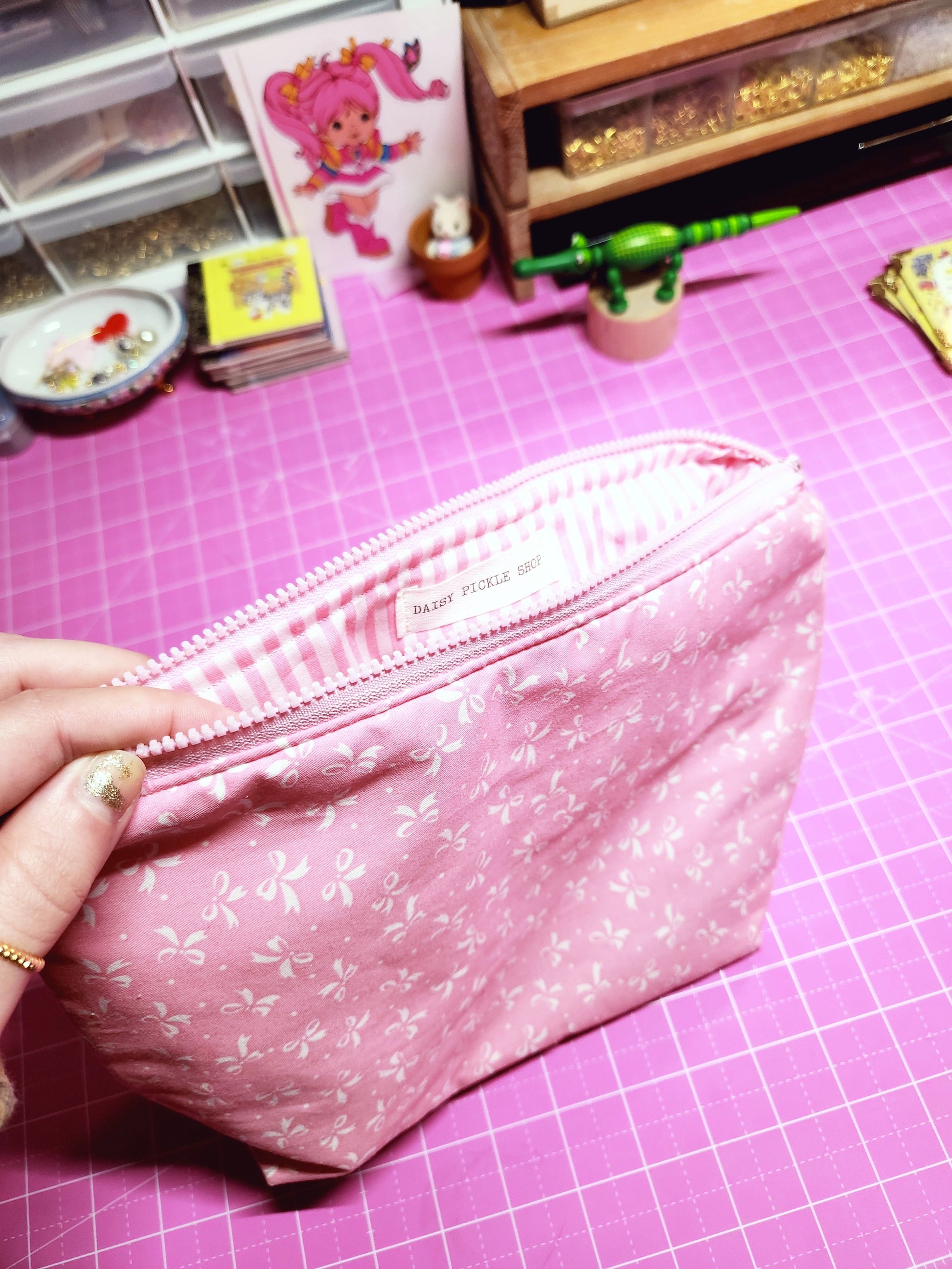 Pink fabric with floral pattern on a pink grid background
