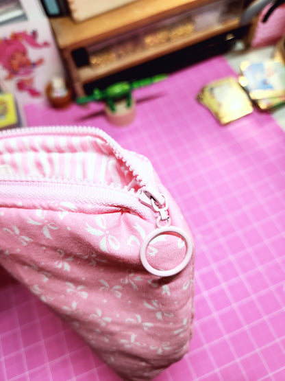 Pink fabric with a button on a pink grid background