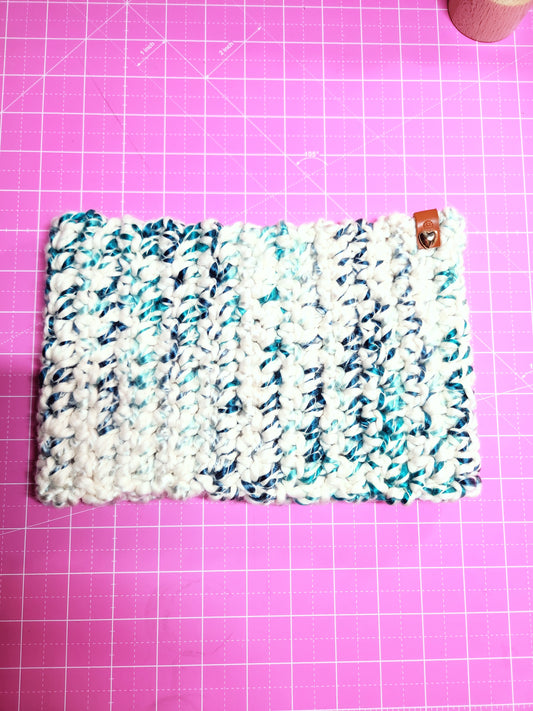 Textured fabric pouch on a pink grid background