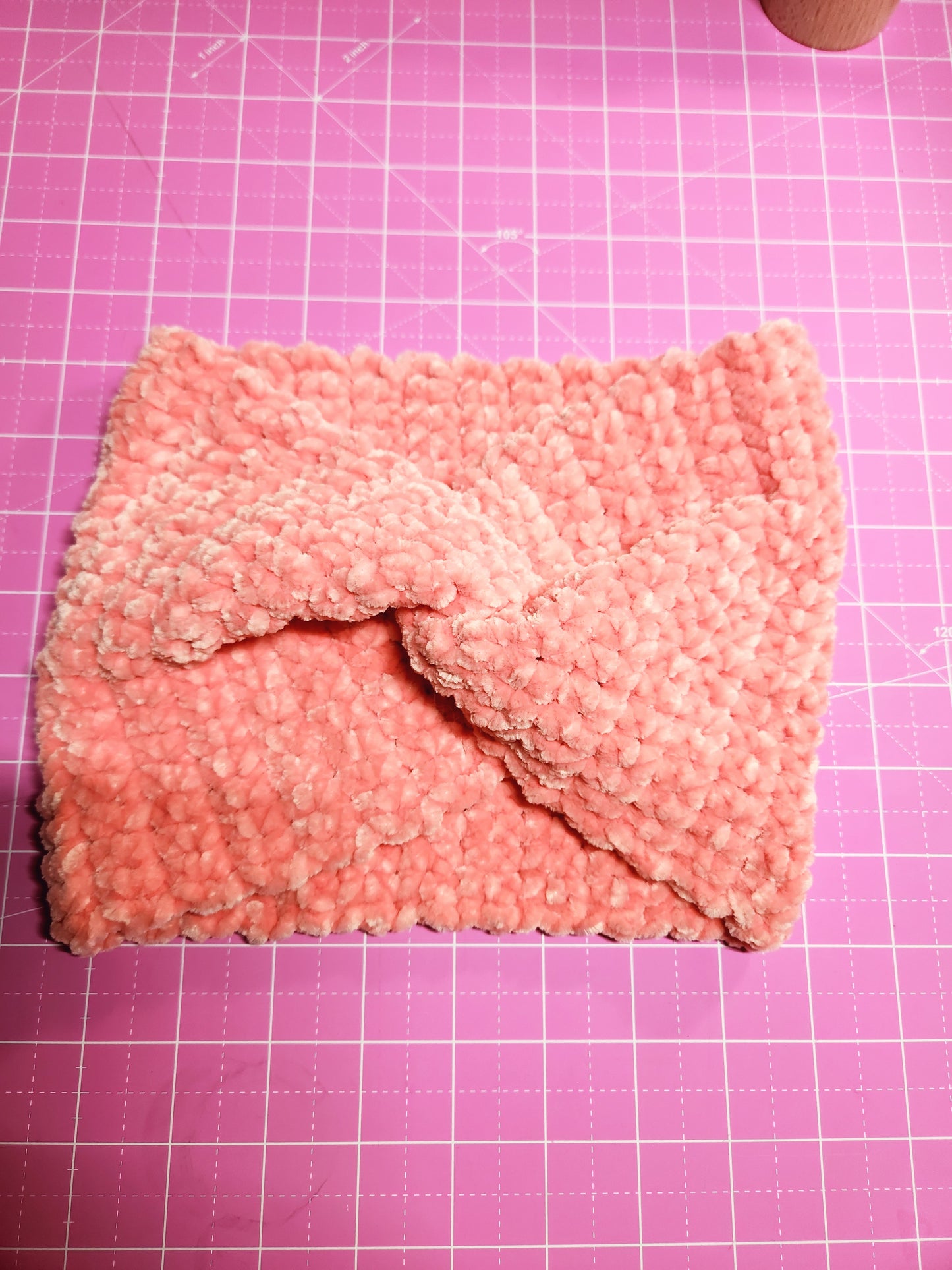 Pink textured fabric on a pink grid background
