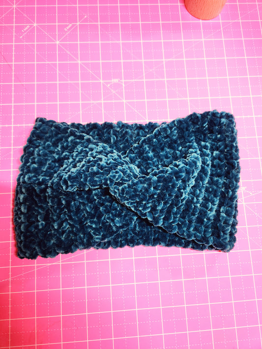 Blue knitted fabric on a pink grid background