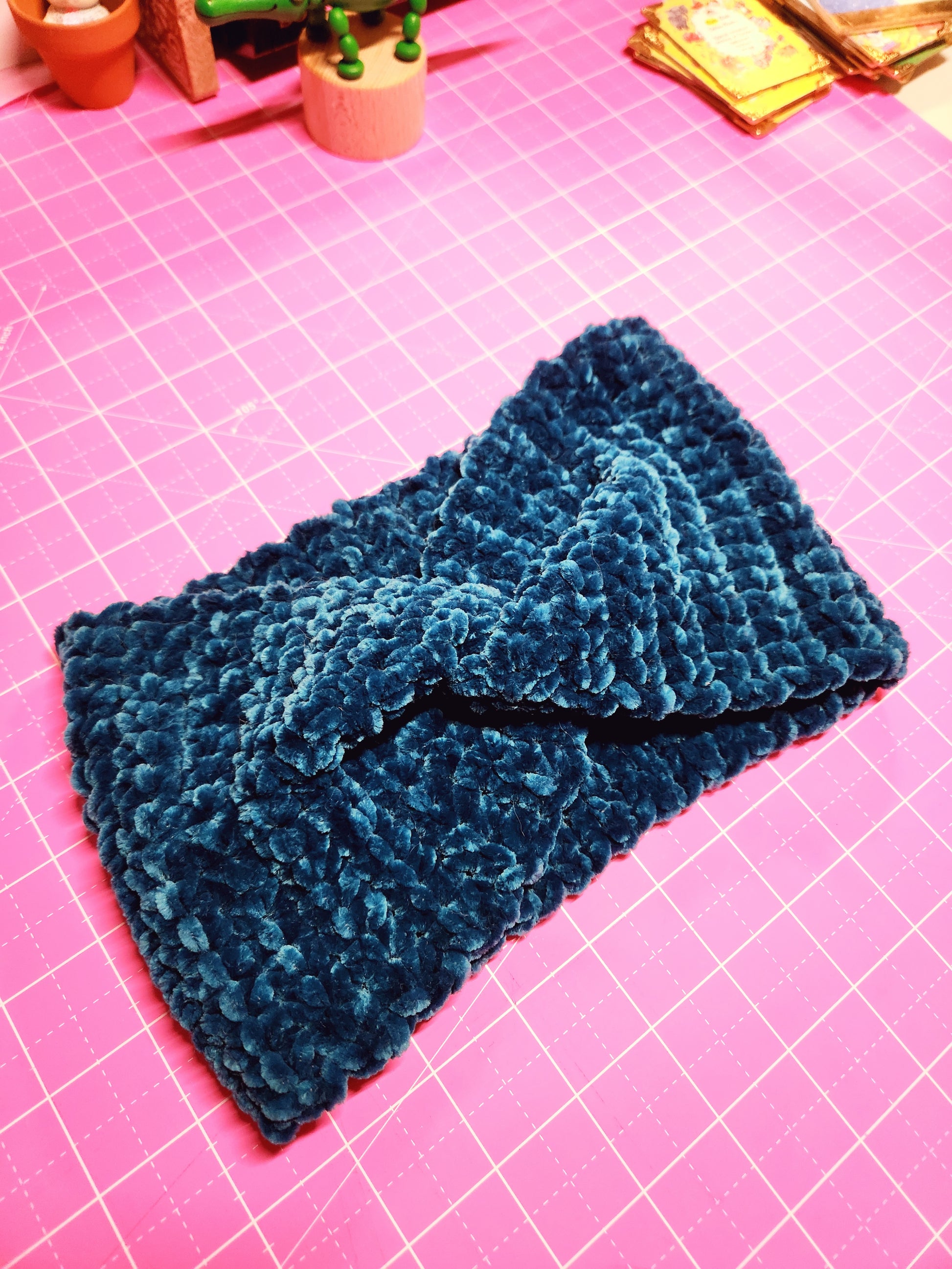 Blue textured fabric on a pink grid background