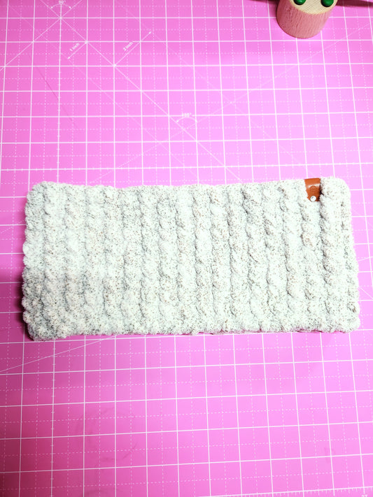 White textured phone case on a pink grid background