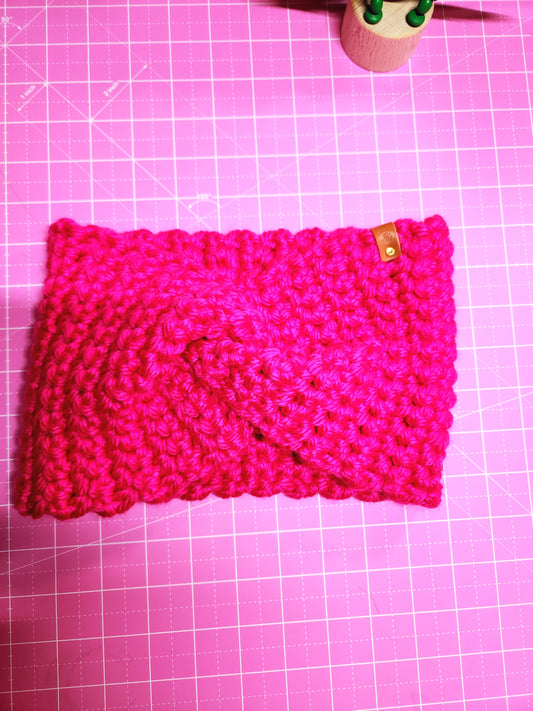 Pink knitted pouch on a pink grid background