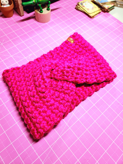 Pink knitted pouch on a pink grid background