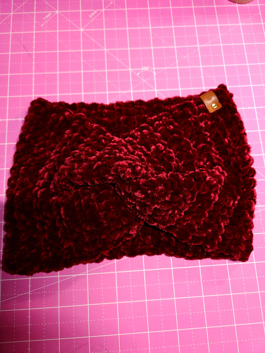 Red knitted headband on a pink grid background