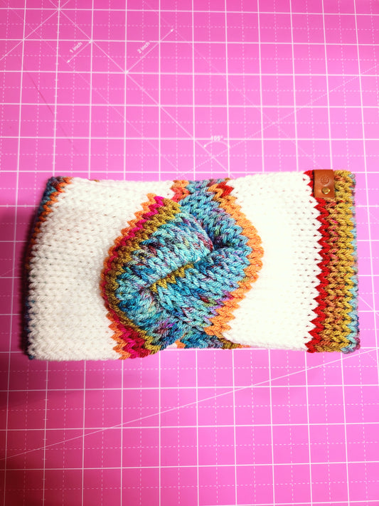 Colorful knitted phone case on a pink grid background