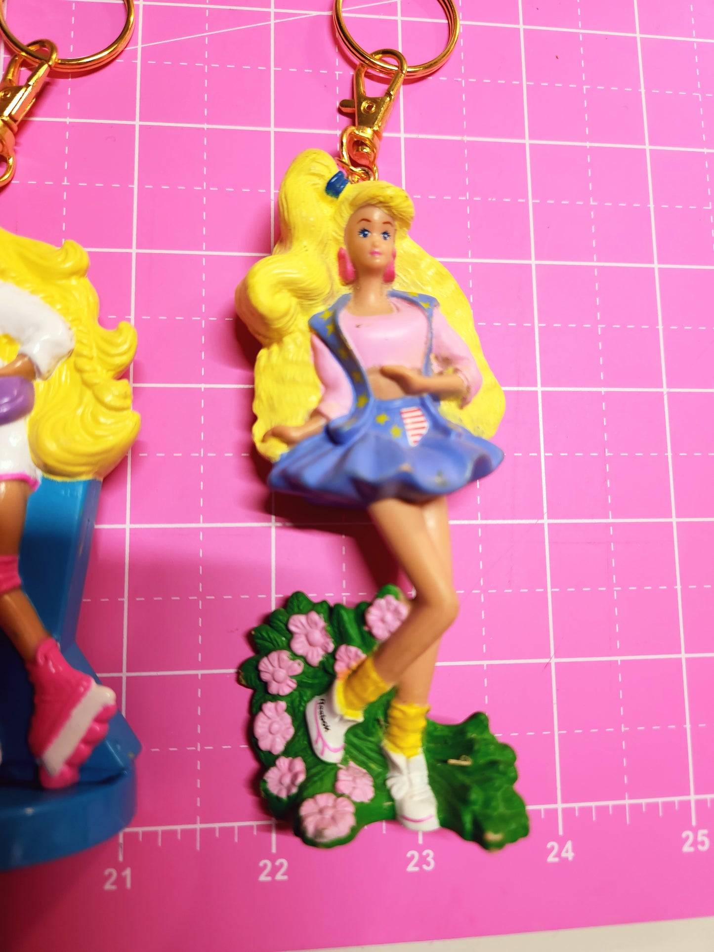 Toy figure on a pink cutting mat with measurements