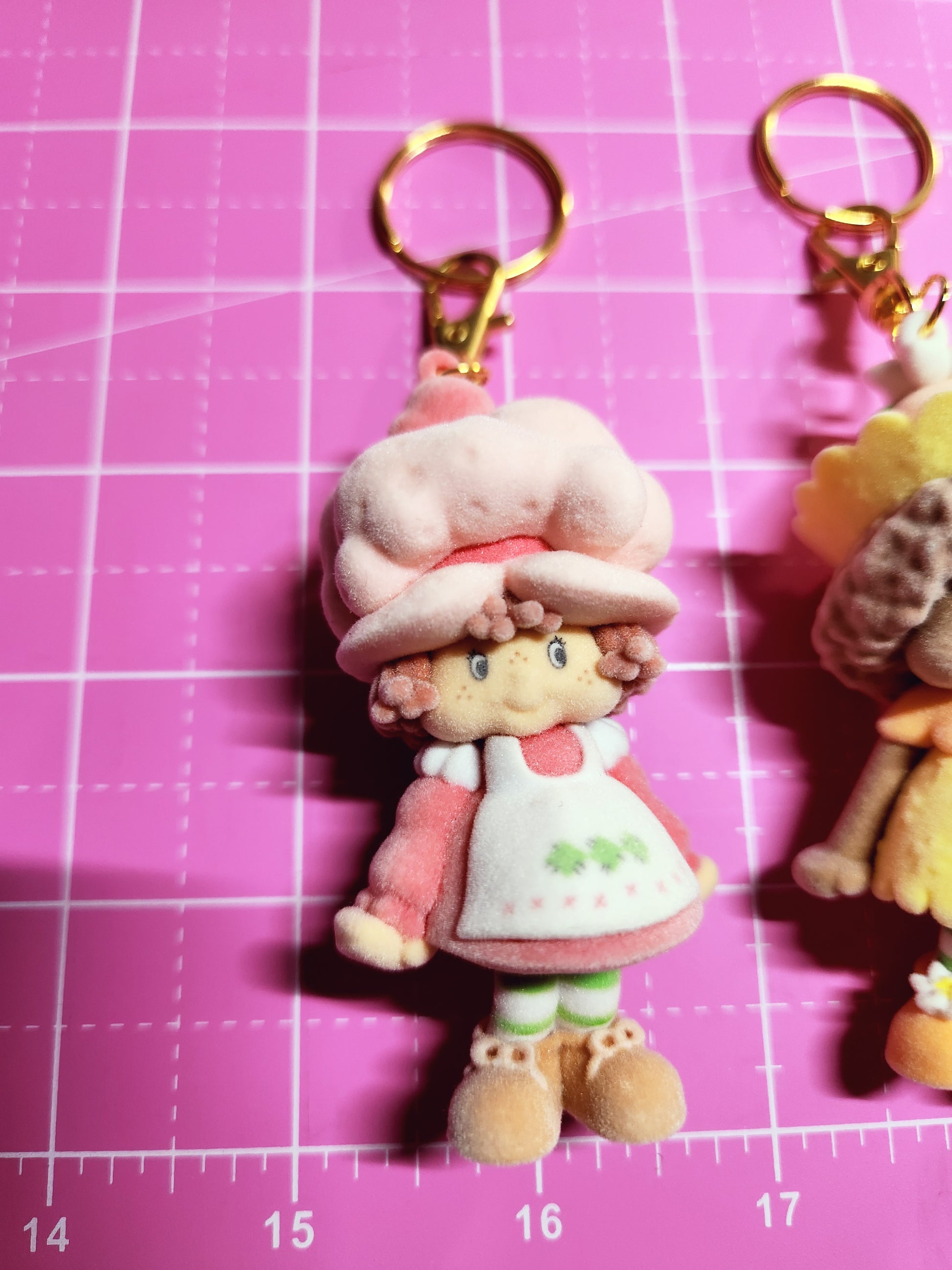 Keychain with a cartoon character on a pink grid background