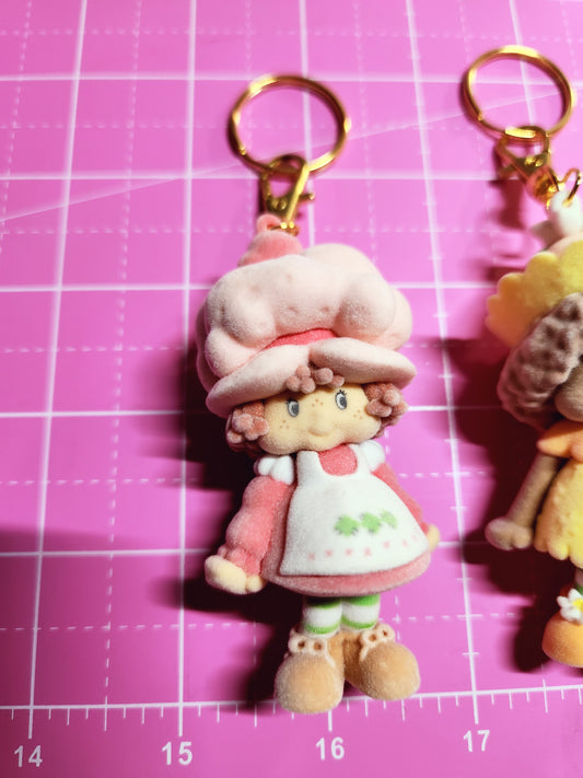 Keychain with a cartoon character on a pink grid background