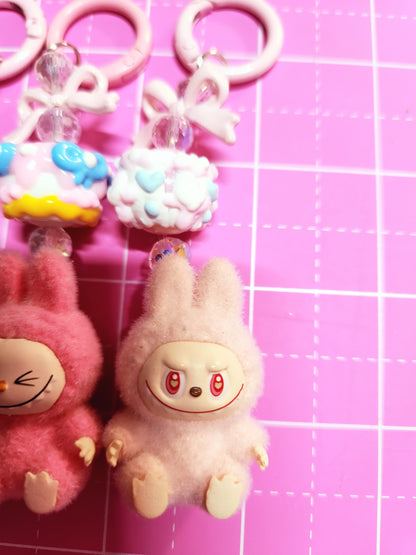 Toy monkey and other toys on a pink grid background