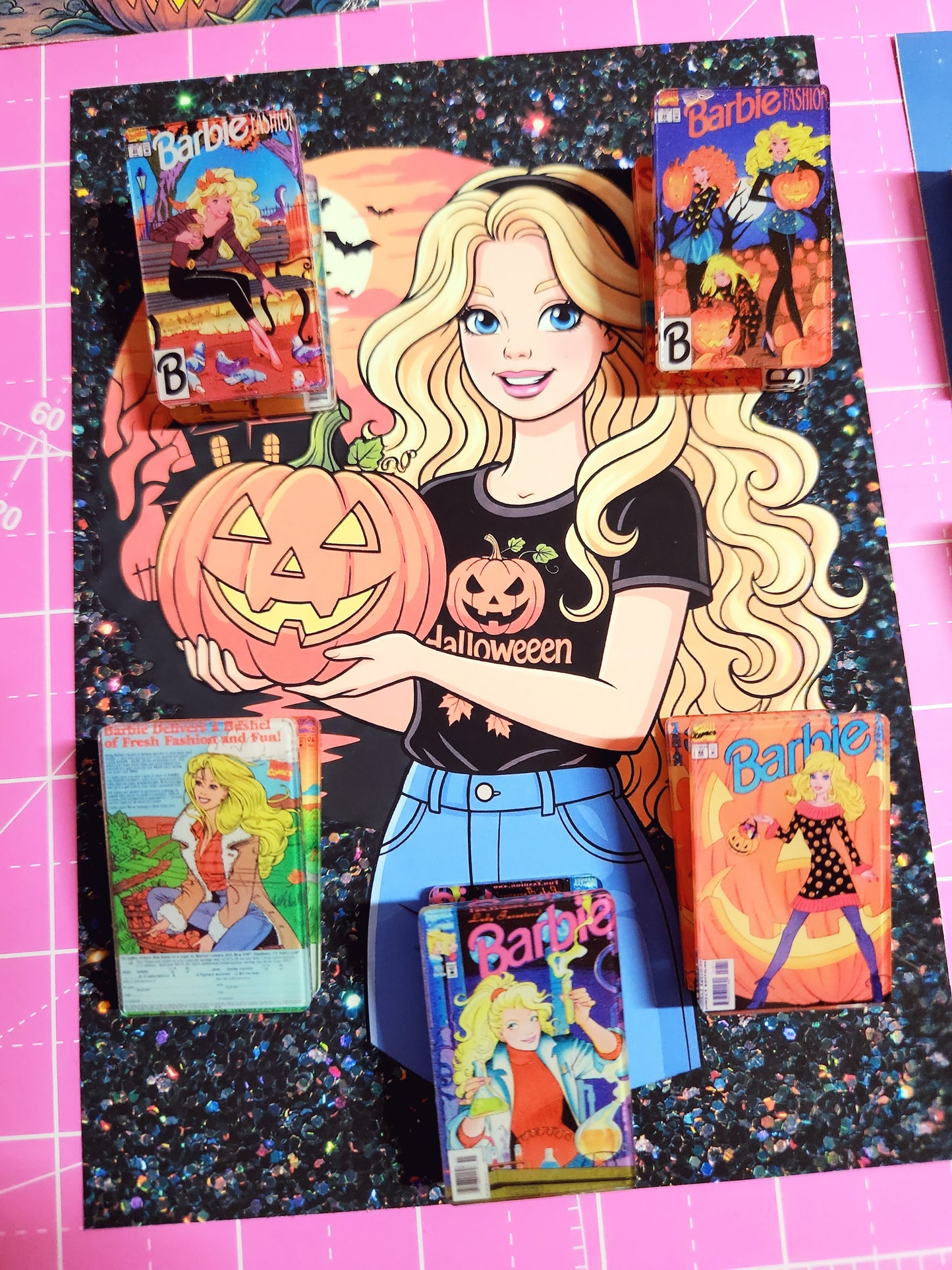 Barbie Halloween-themed books on a pink cutting mat