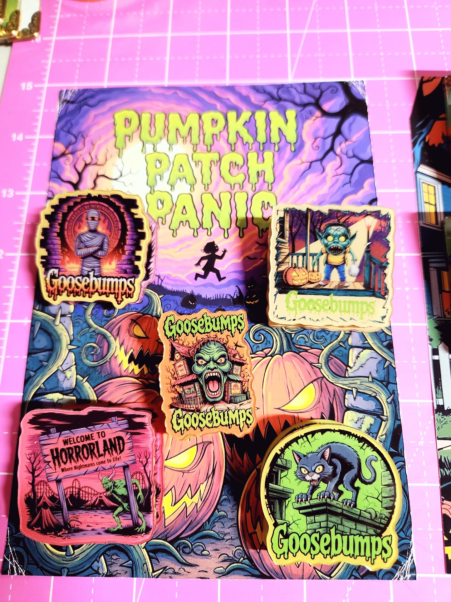 Colorful Halloween-themed product packaging on a pink grid background