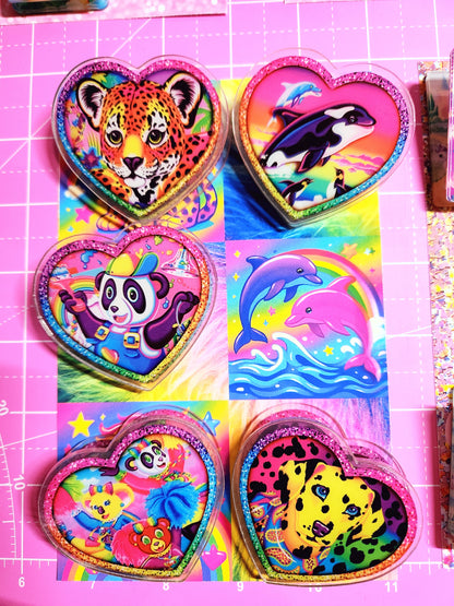 Colorful heart-shaped stickers with animal designs on a pink grid background