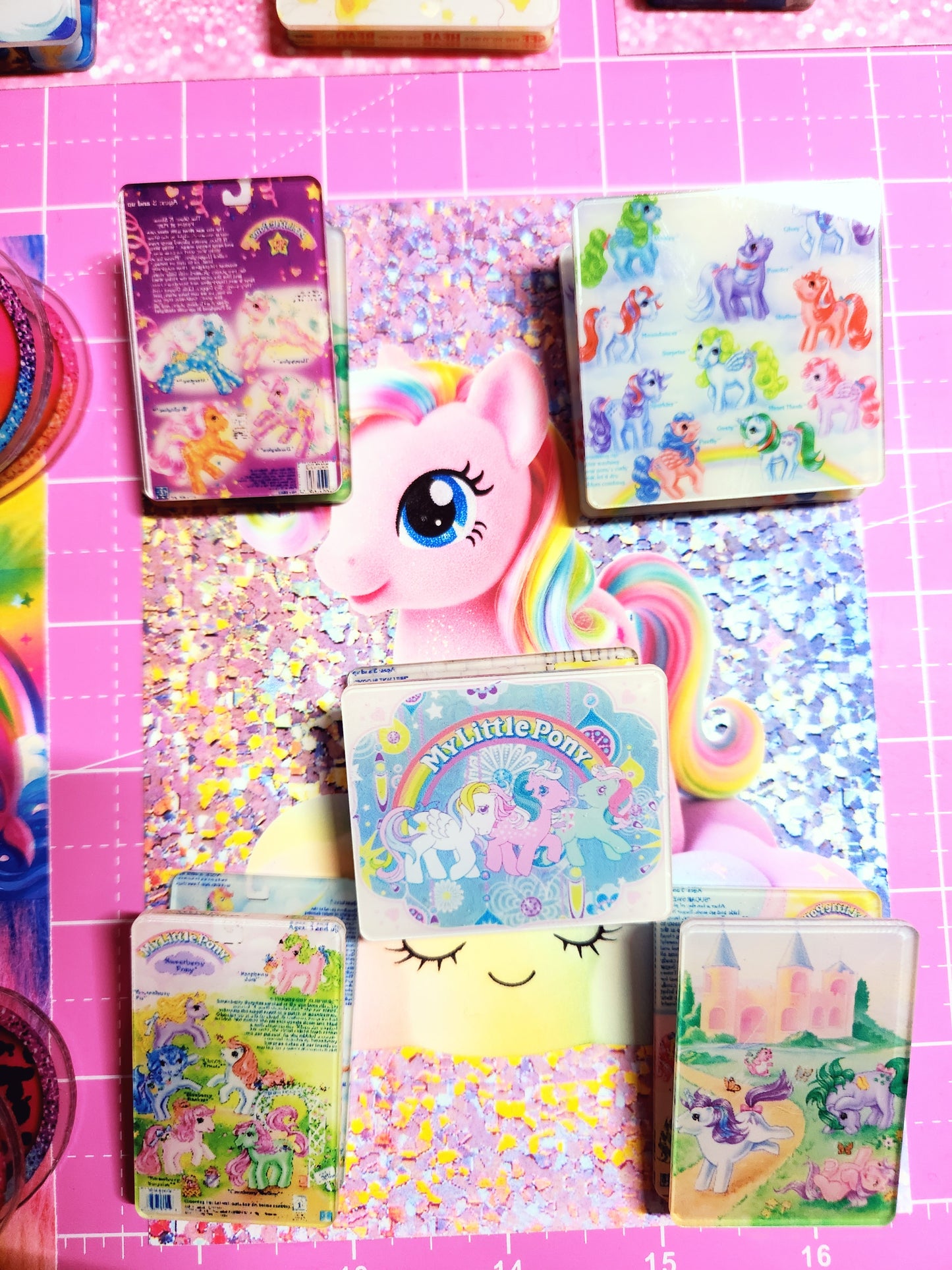 Colorful children's stickers with cartoon characters on a pink grid background