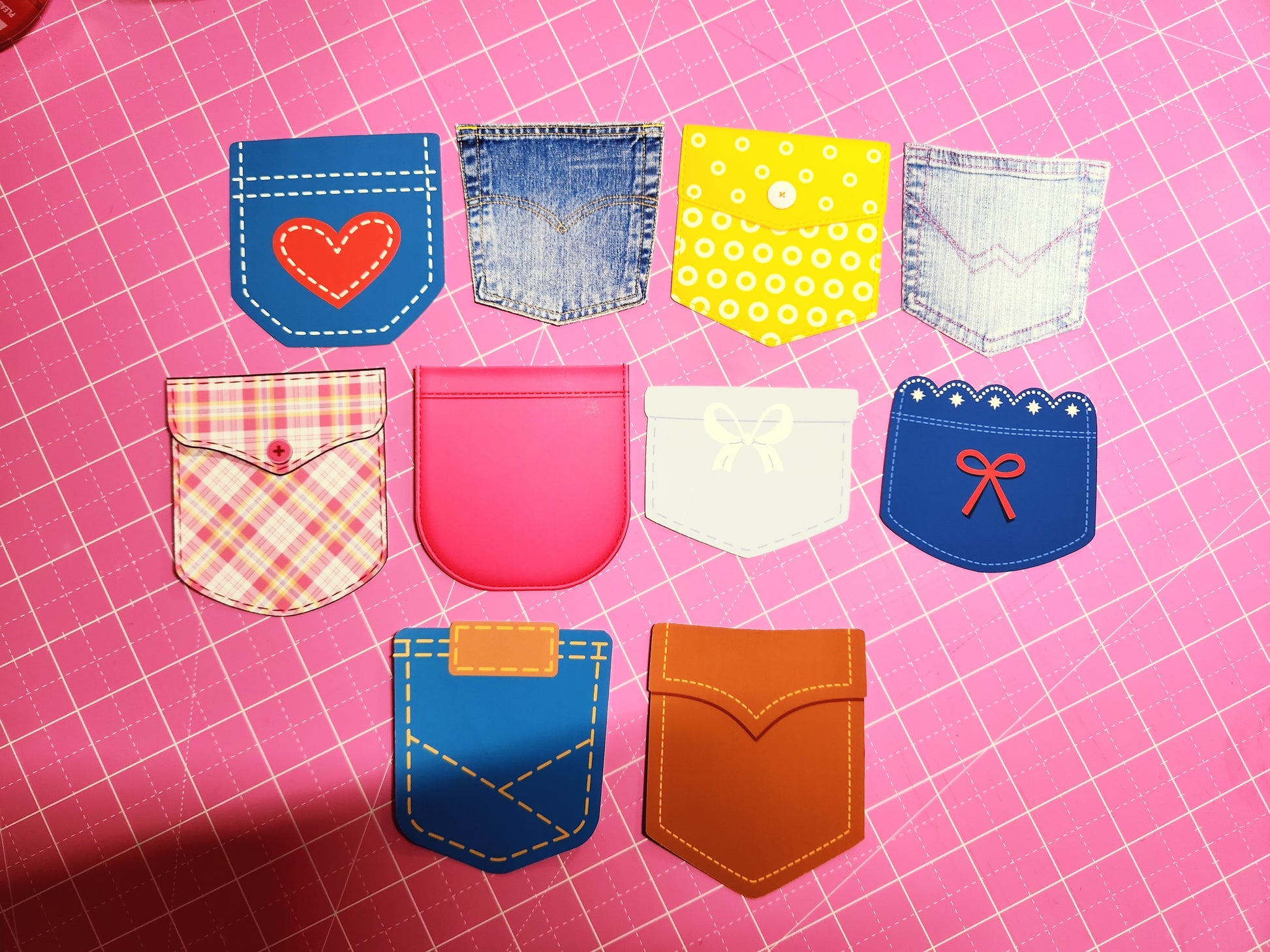 Collection of colorful fabric pockets on a pink grid background